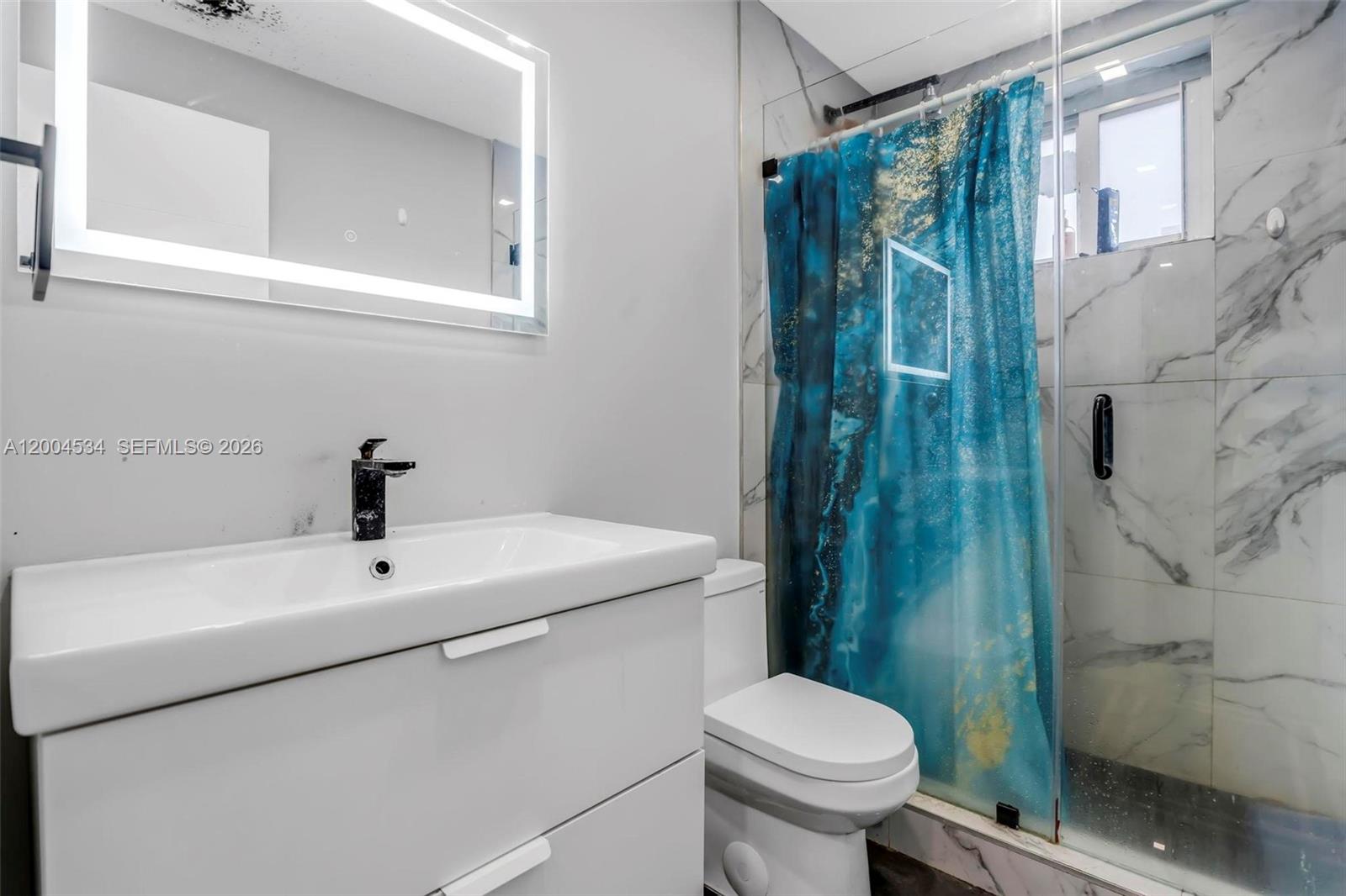 1741 Northwest 44th Street Miami, FL 33142 - Photo 19 of 45 a bathroom with a sink toilet and shower