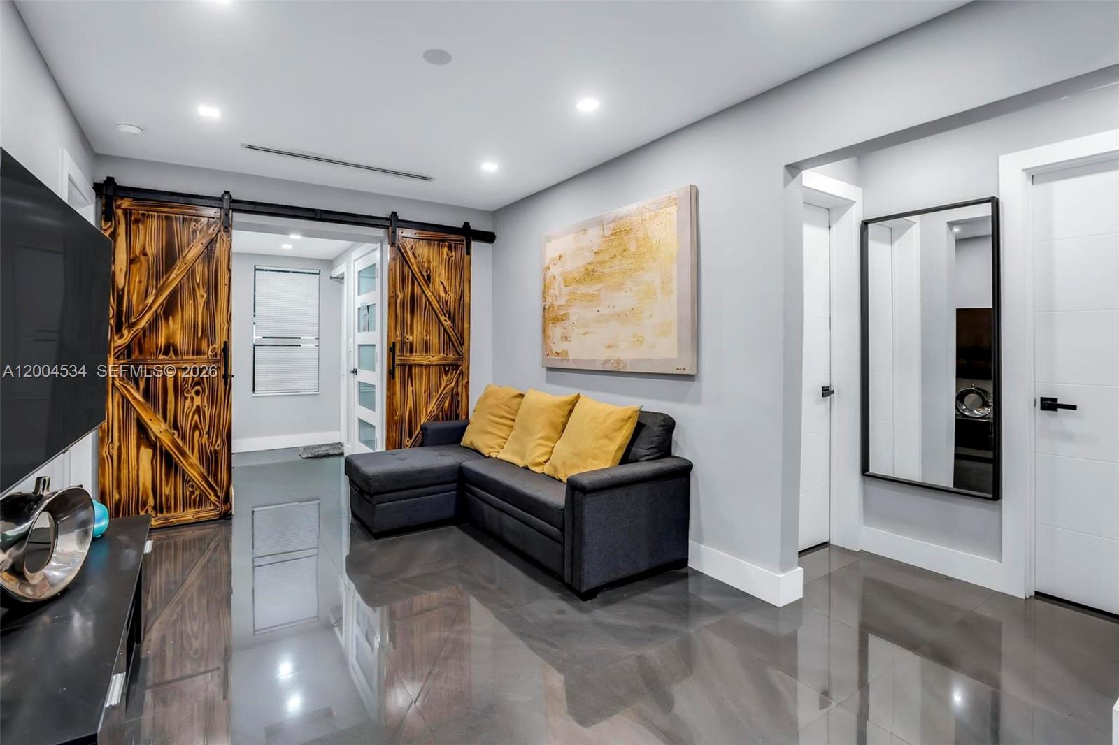 1741 Northwest 44th Street Miami, FL 33142 - Photo 2 of 45 a living room with furniture and a flat screen tv