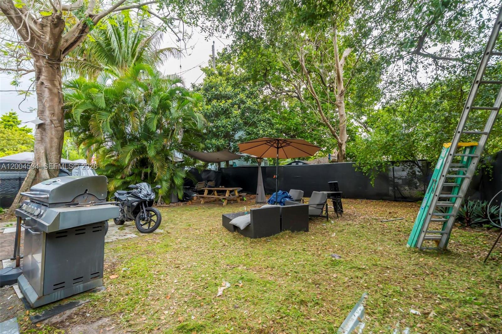 1741 Northwest 44th Street Miami, FL 33142 - Photo 30 of 45 a view of backyard with swimming pool and seating space