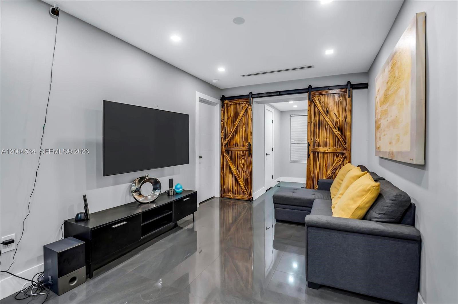 1741 Northwest 44th Street Miami, FL 33142 - Photo 3 of 45 a living room with furniture and a flat screen tv