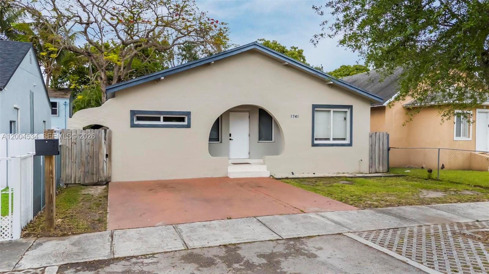 1741 Northwest 44th Street Miami, FL 33142 - Photo 34 of 45 a front view of a house with garden