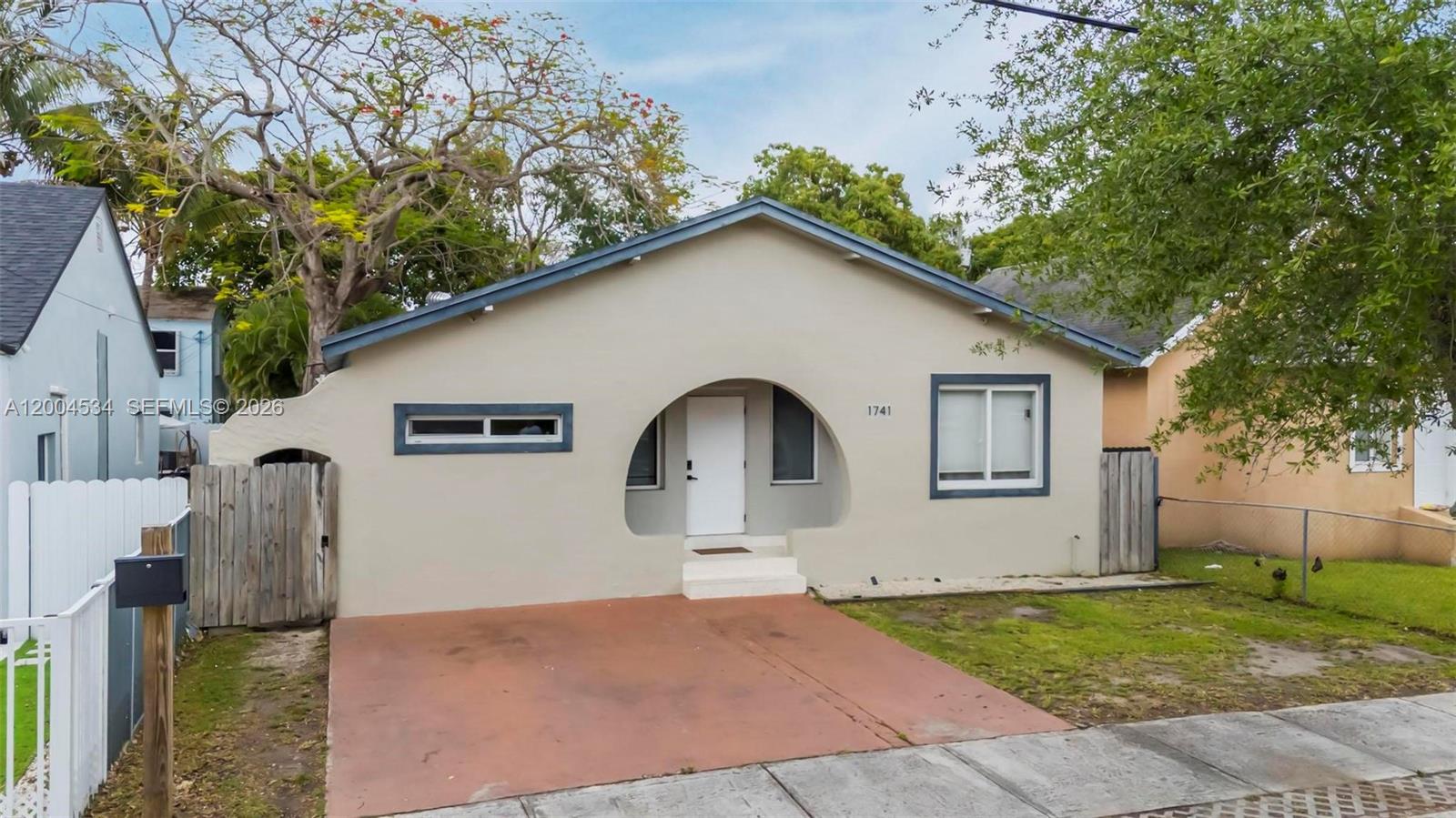 1741 Northwest 44th Street Miami, FL 33142 - Photo 35 of 45 a front view of a house with garden