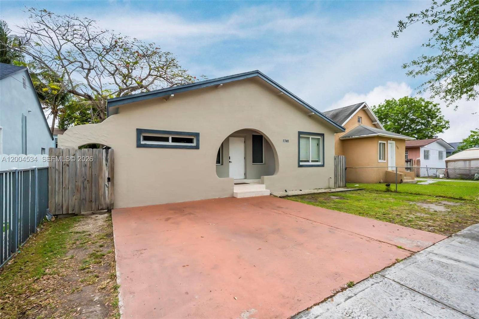 1741 Northwest 44th Street Miami, FL 33142 - Photo 37 of 45 a view of a house with backyard and a tree