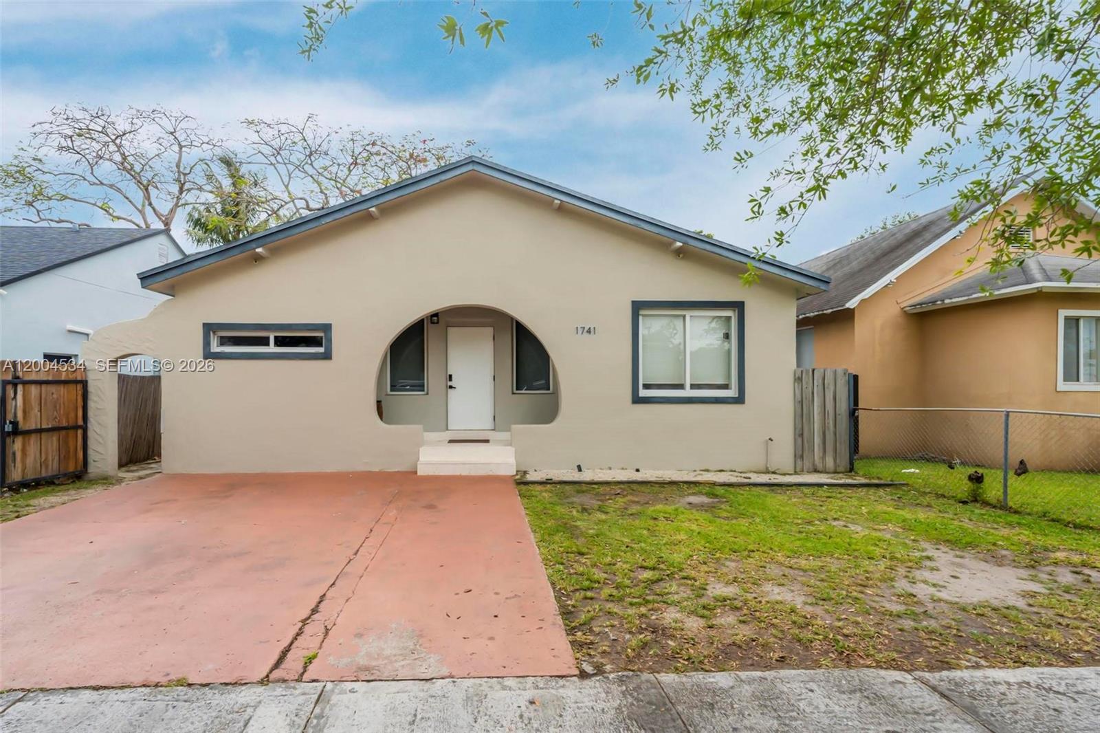 1741 Northwest 44th Street Miami, FL 33142 - Photo 40 of 45 a front view of a house with a yard