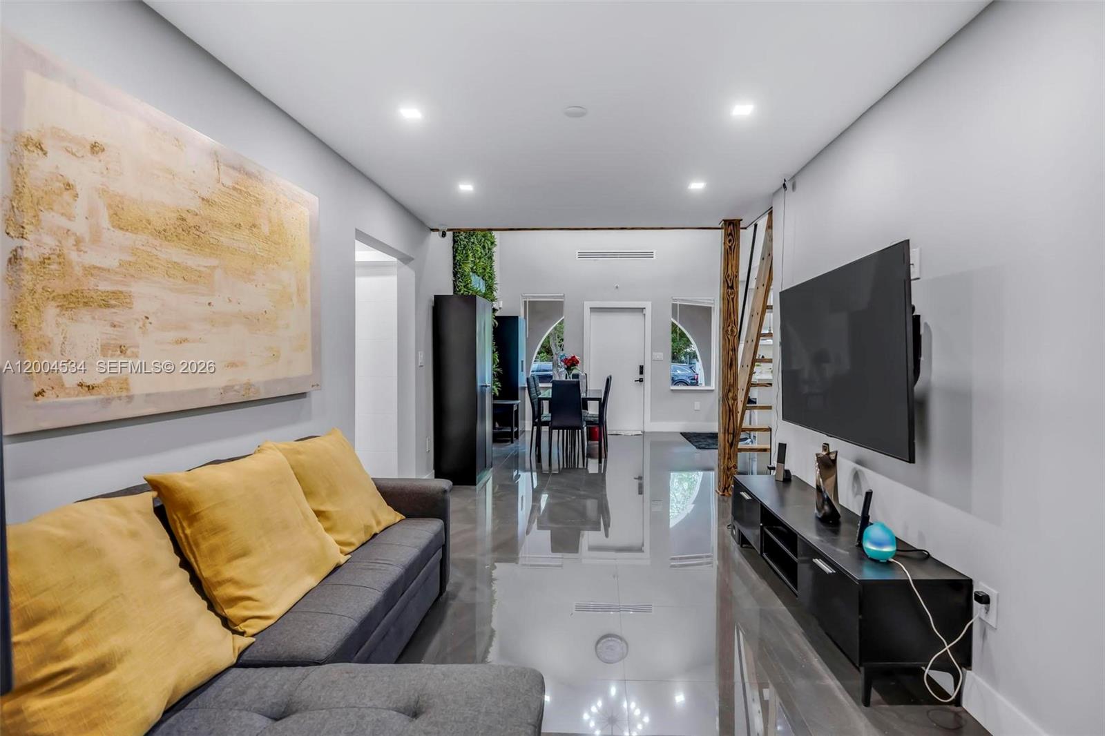 1741 Northwest 44th Street Miami, FL 33142 - Photo 4 of 45 a living room with furniture and a flat screen tv