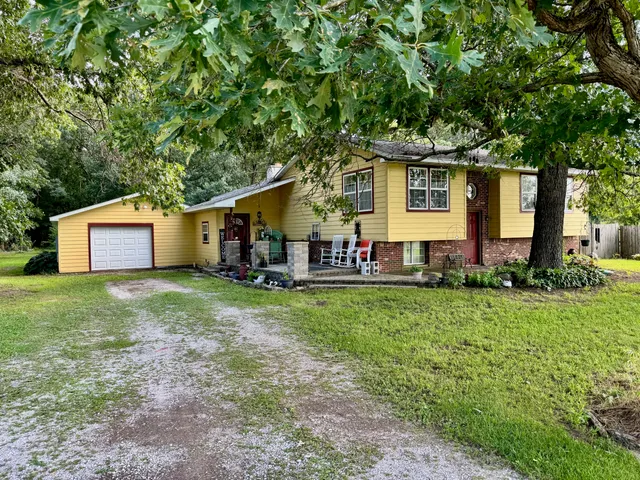 a front view of house with a garden