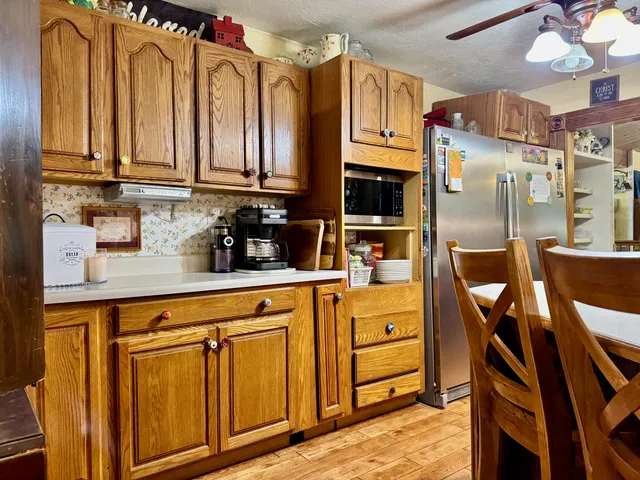 a kitchen with stainless steel appliances granite countertop a refrigerator and cabinets