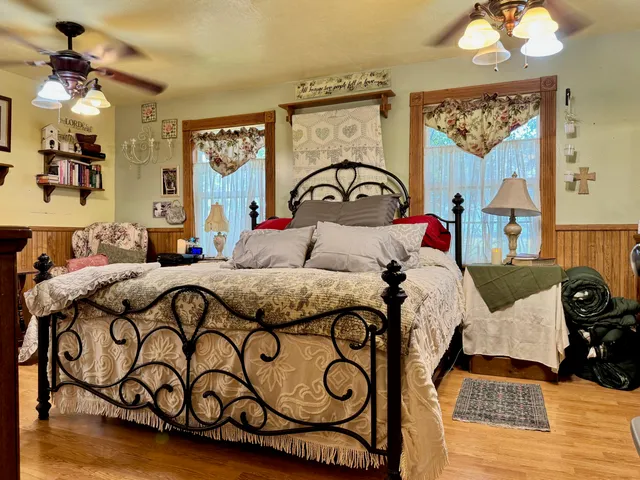 a bedroom with a bed and a chandelier