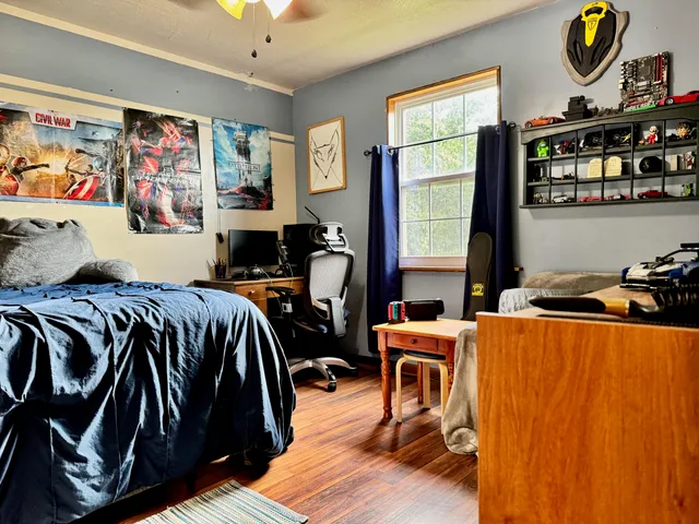 a bedroom with a bed and furniture with window