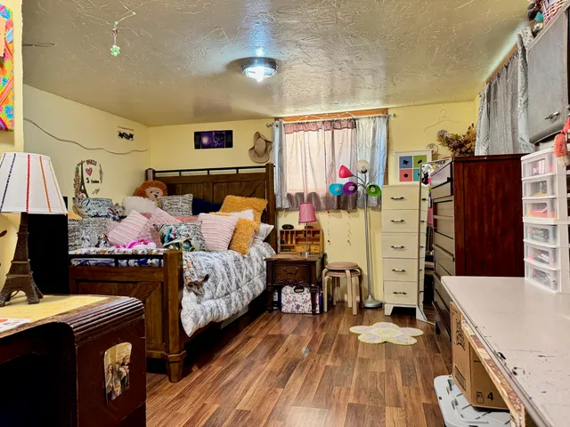 a bedroom with a bed and a desk