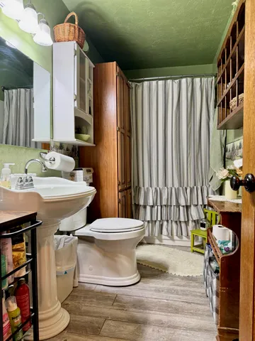 a bathroom with a sink toilet and shower