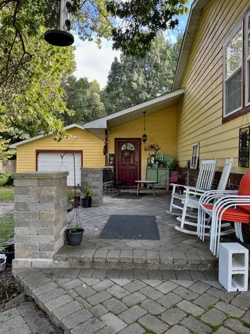 a view of a patio with table and chairs with wooden fence and plants