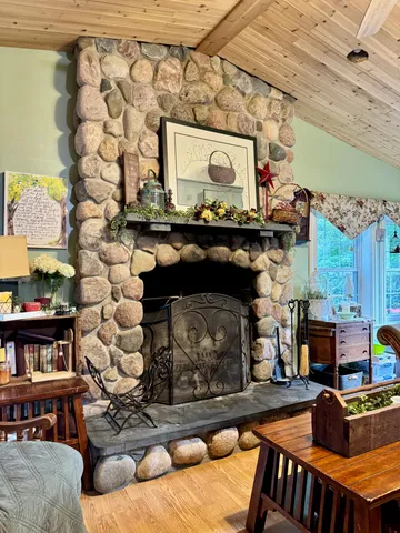 a living room with fireplace furniture and a wooden floor
