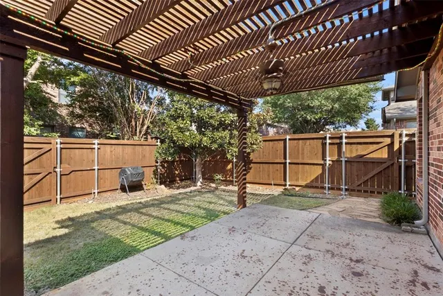 a view of a backyard with wooden fence