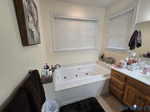 a bedroom with a bed a mirror and window