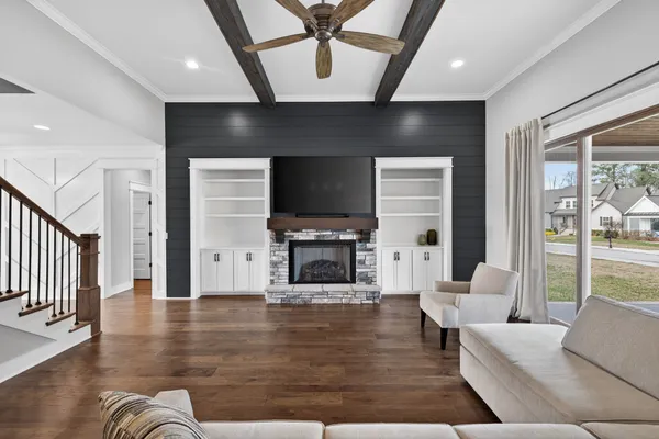 a kitchen with stainless steel appliances granite countertop wooden floors and white cabinets