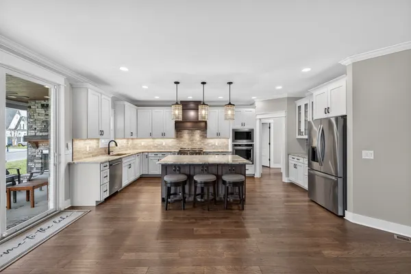 a kitchen with stainless steel appliances a refrigerator stove and sink