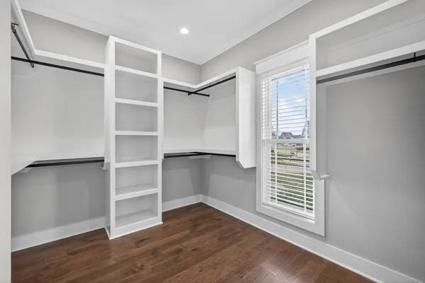 a bed room with a bed and a chair
