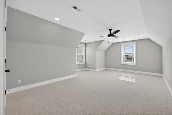 a dining room with furniture water view and a floor to ceiling window