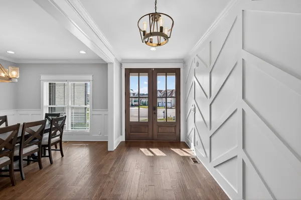 a view of entryway and hall with wooden floor