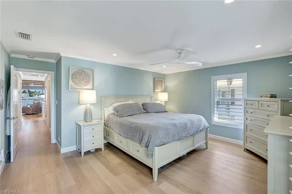 a spacious bedroom with a bed and a cabinets