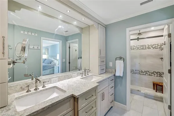 a bathroom with a granite countertop sink mirror and double