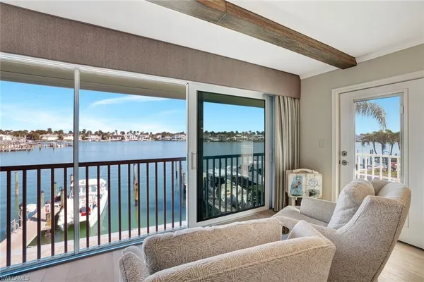 a balcony with furniture and a large window