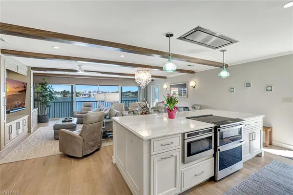 a kitchen with a stove and a chandelier