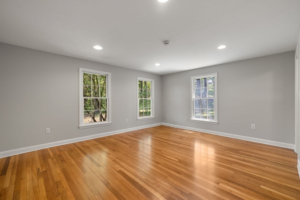 49 Walpole Street Dover, MA 02030 - Photo 21 of 40 a view of an empty room with wooden floor and a window