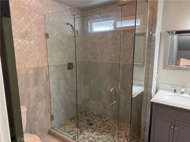 a bathroom with a shower and a sink