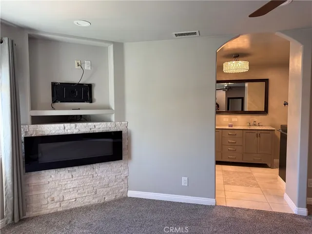a living room with a fireplace and a flat screen tv
