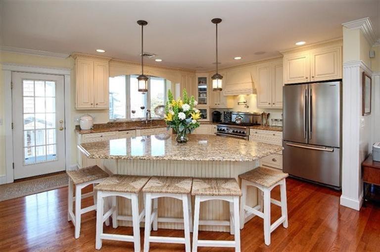 163 Jefferson Road Bourne, MA 02532 - Photo 9 of 35 a kitchen with stainless steel appliances granite countertop a kitchen island hardwood floor and a large window