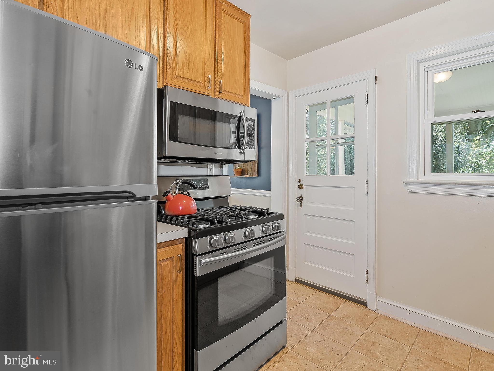 9504 Seminole Street Silver Spring, MD 20901 - Photo 11 of 25 a kitchen with stainless steel appliances granite countertop a refrigerator stove and microwave