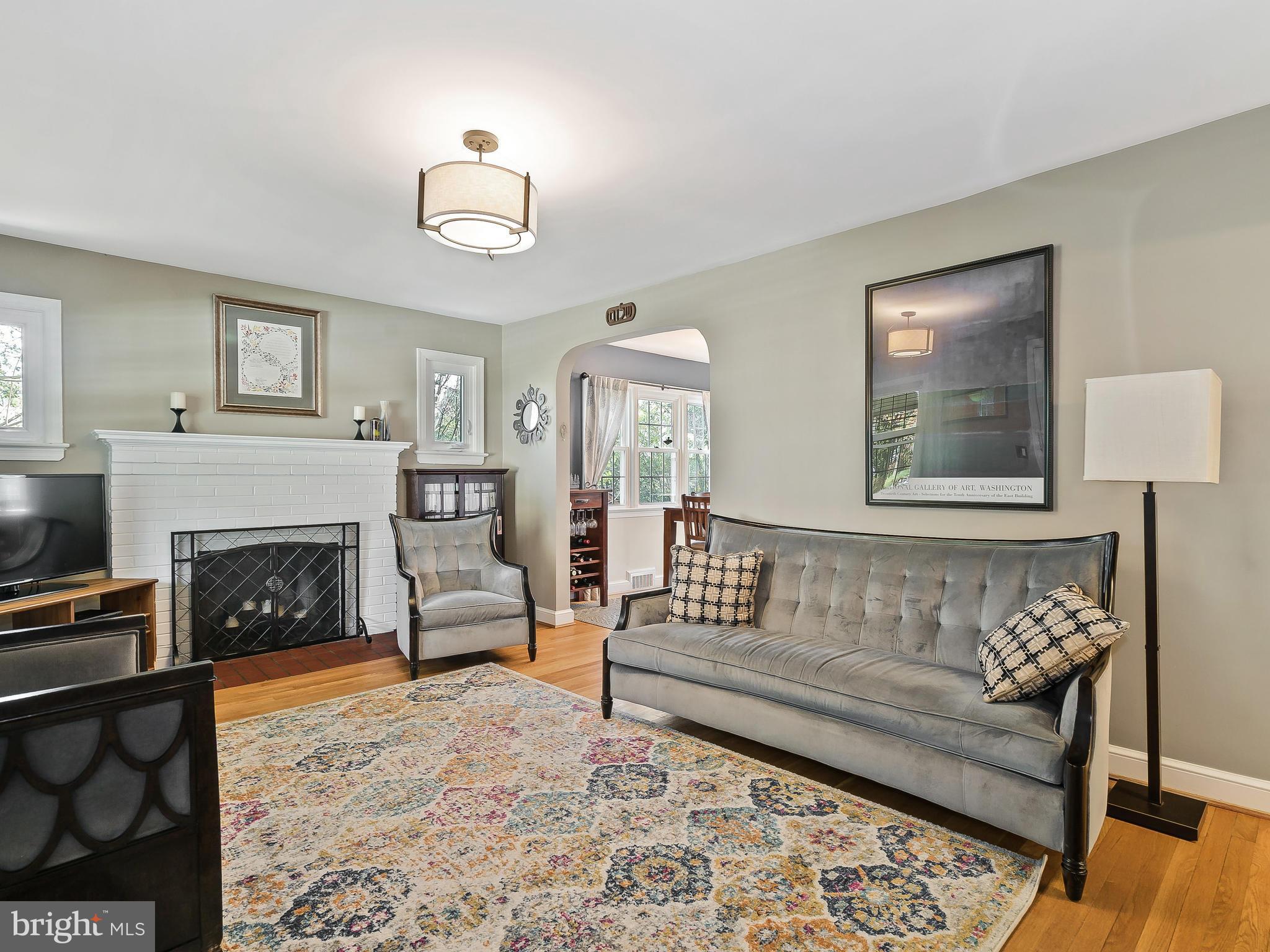 9504 Seminole Street Silver Spring, MD 20901 - Photo 6 of 25 a living room with furniture and a fireplace