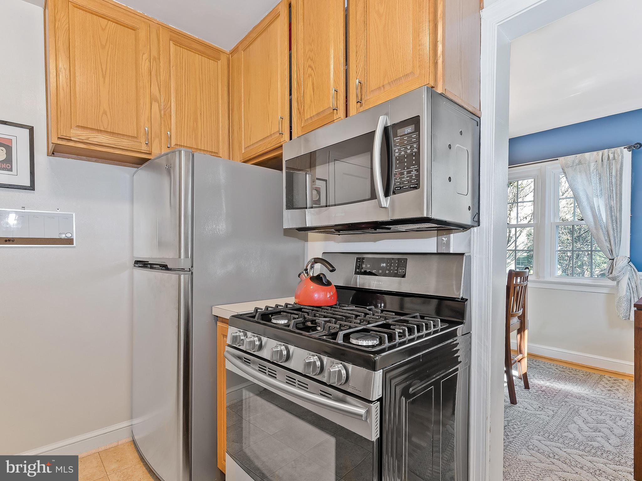 9504 Seminole Street Silver Spring, MD 20901 - Photo 9 of 25 a kitchen with stainless steel appliances granite countertop a stove and a refrigerator