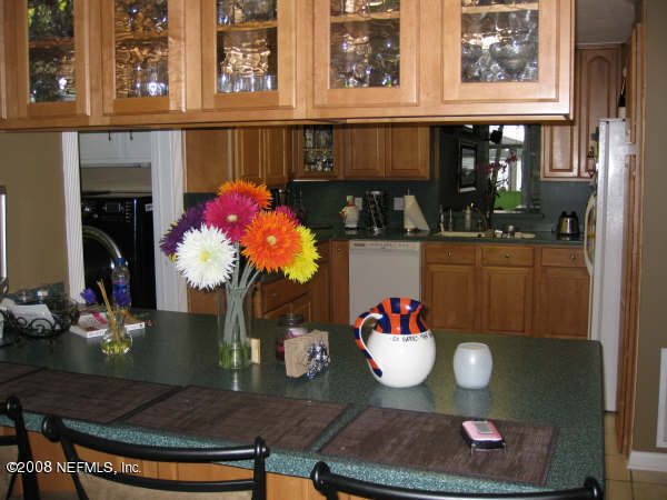 3050 Magnolia Road Orange Park, FL 32065 - Photo 8 of 15 a table with wine bottles and glasses on it