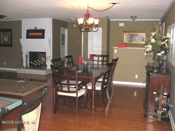 3050 Magnolia Road Orange Park, FL 32065 - Photo 9 of 15 a view of a dining room with furniture and chandelier