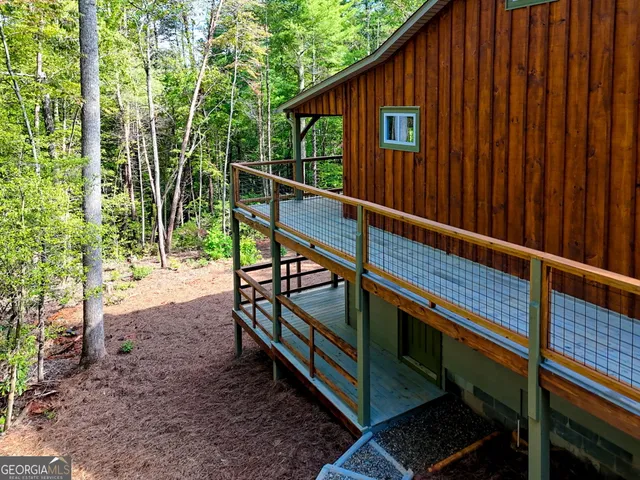 a view of a house with a yard siting area and garden