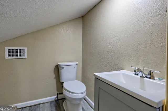 a view of a bathroom with wooden door