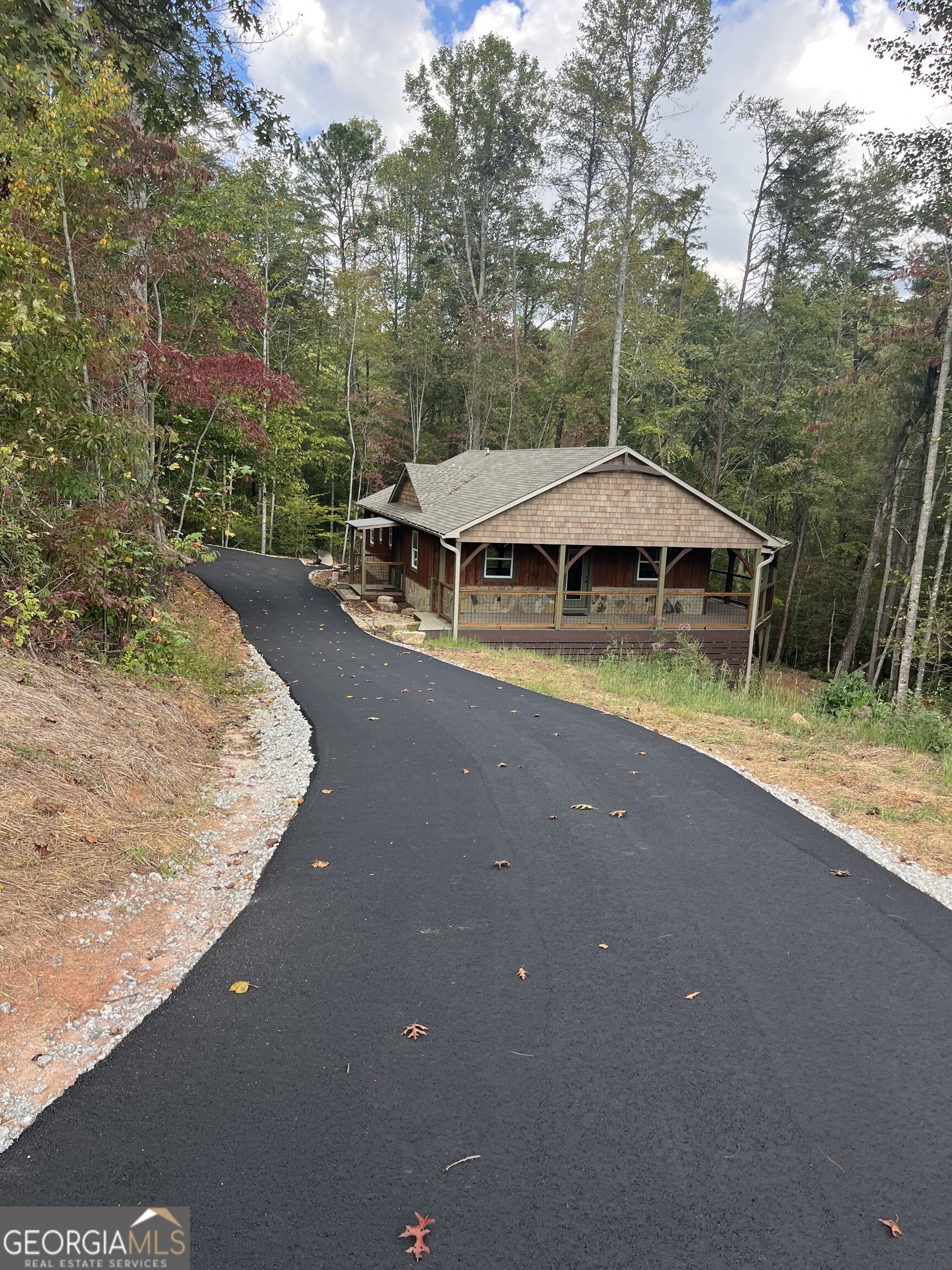 108 Olds Mountain Rabun Gap, GA 30568 - Photo 9 of 73 a view of a house with pool and chairs under an umbrella