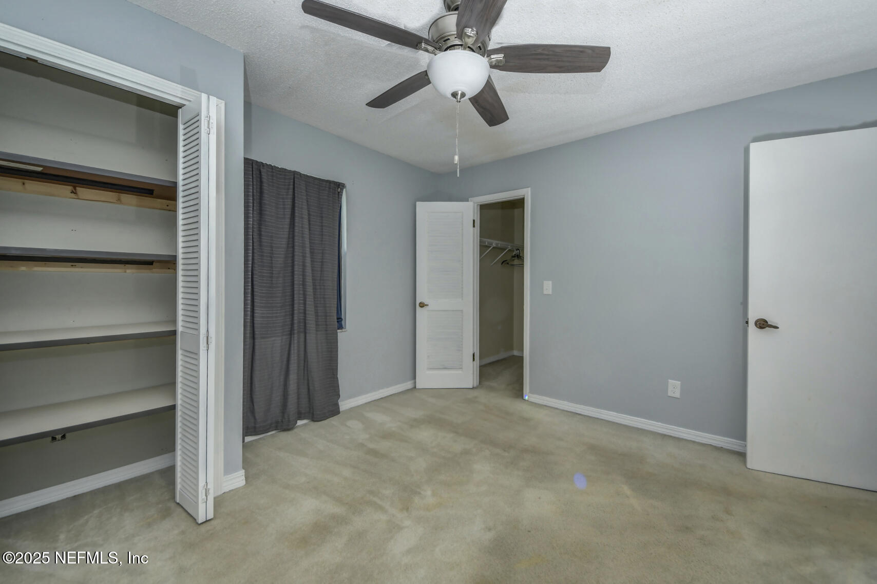 12876 Squirrel Tree Court Jacksonville, FL 32246 - Photo 20 of 33 a view of an empty room with a ceiling fan