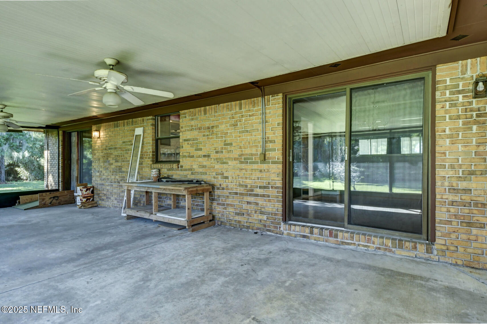 12876 Squirrel Tree Court Jacksonville, FL 32246 - Photo 7 of 33 a view of an empty room with a fireplace and a large window