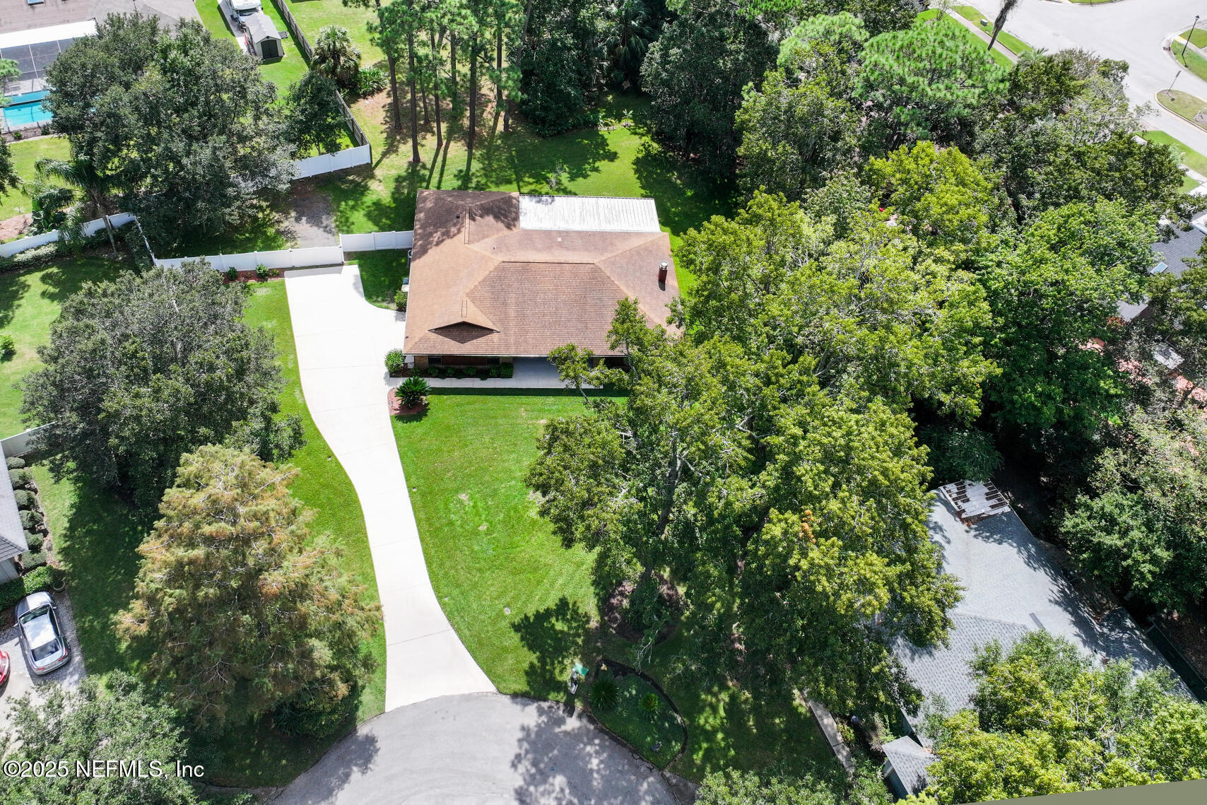 12876 Squirrel Tree Court Jacksonville, FL 32246 - Photo 9 of 33 an aerial view of a house with a yard and trees all around