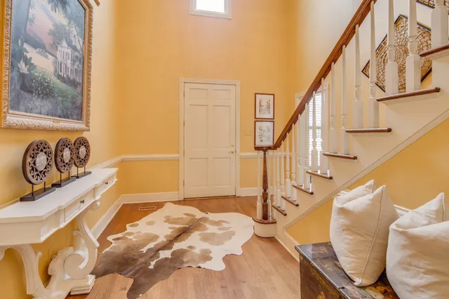 a view of a livingroom with wooden floor and stairs