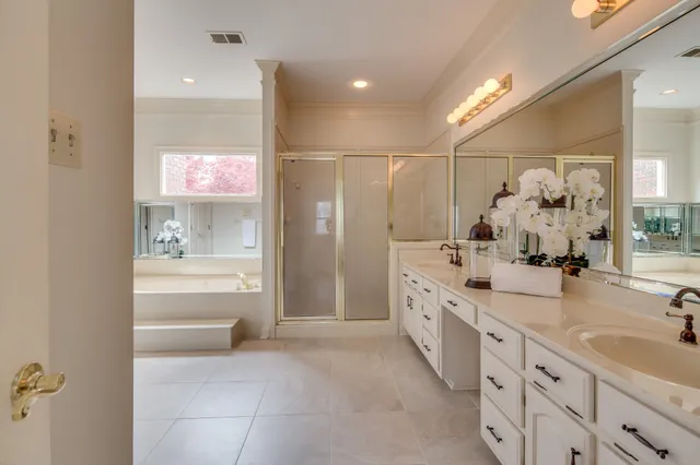 a spacious bathroom with double sink and a mirror