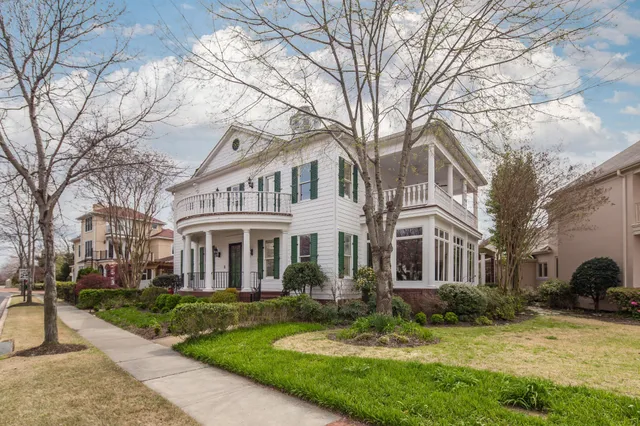 a view of a porch with furniture and a yard