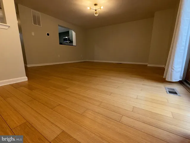 a view of room with wooden floor