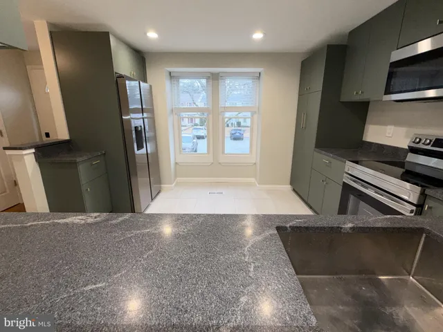 a view of a kitchen with a sink and a stove