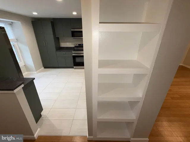 a view of kitchen with refrigerator and stove