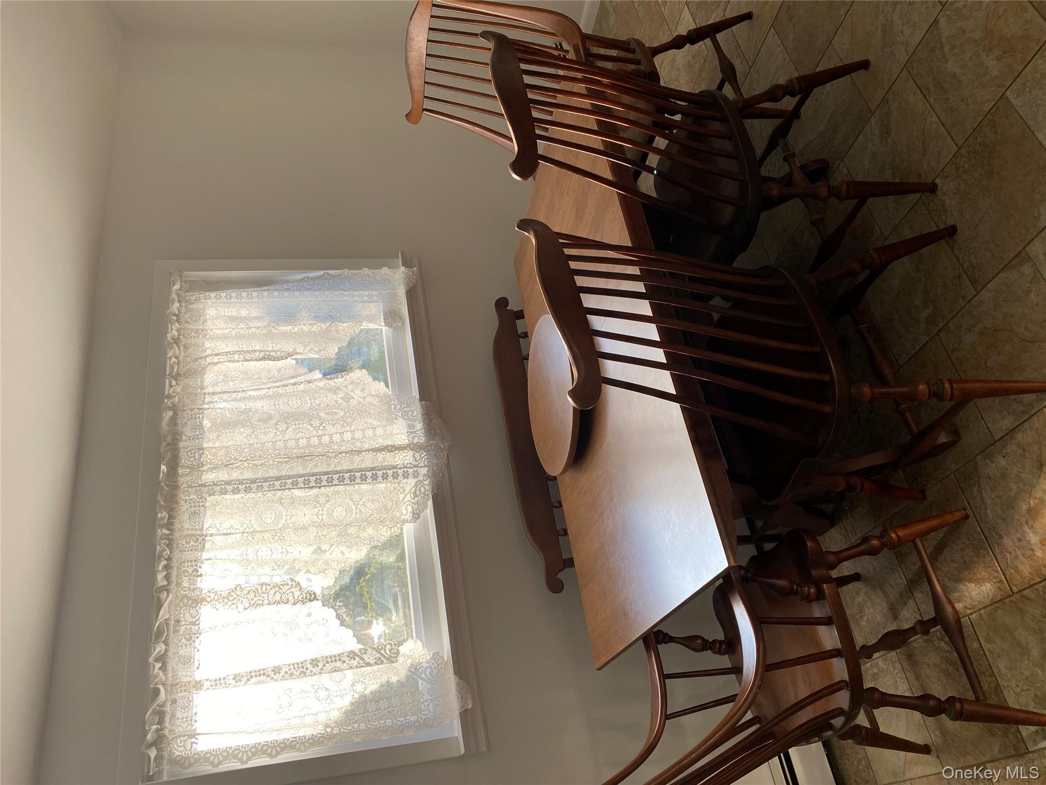 433 Browns Road Nesconset, NY 11767 - Photo 32 of 47 a view of a dining room with furniture and a window